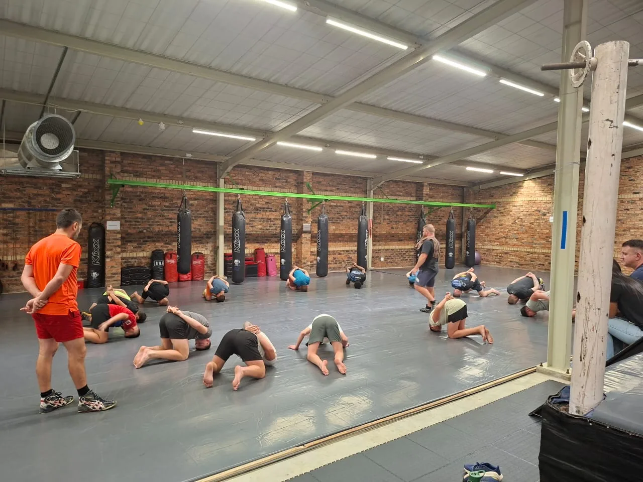 A kickboxing class on the bags at Mighty Warriors