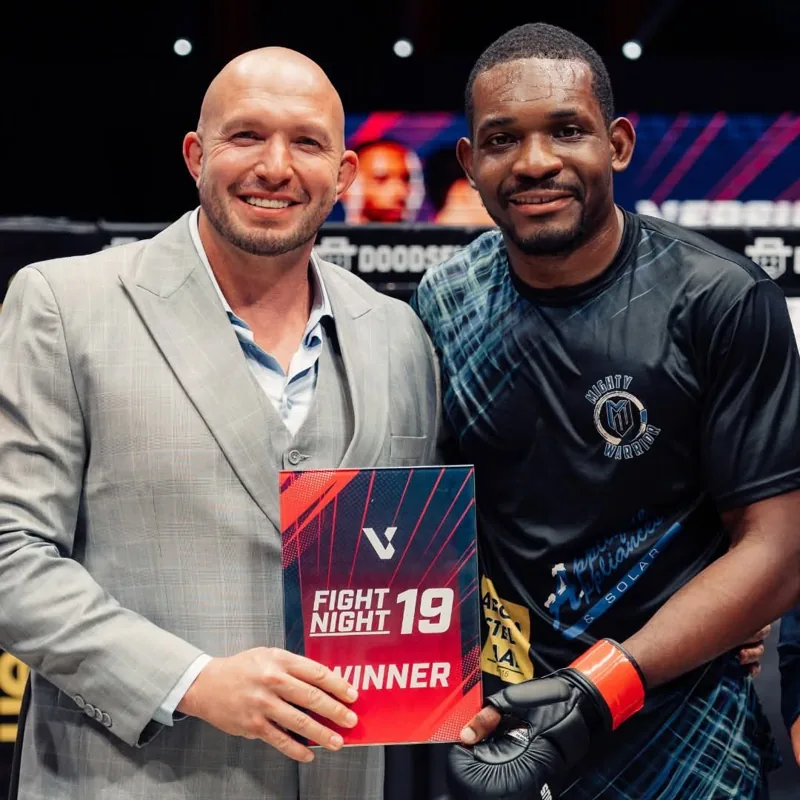 Coach Bart Potgieter with Josiah Obasi and his Fight Night 19 winner card