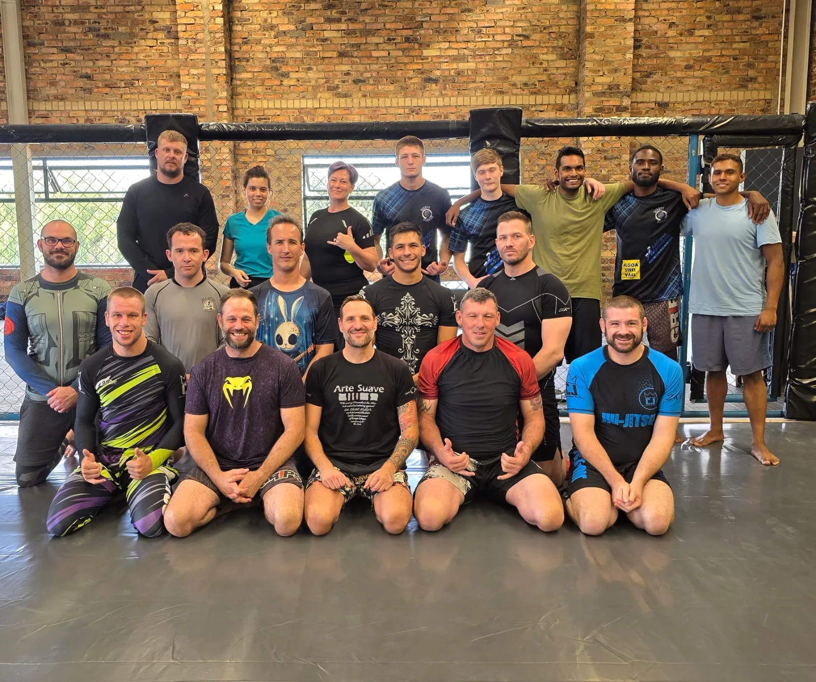 The MMA class in front of the cage at Mighty Warriors